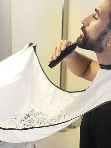 man shaving his beard using a beard bib haor holder